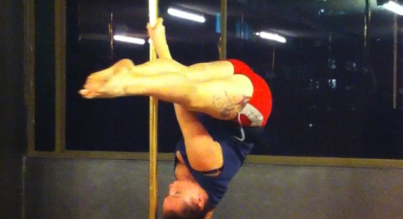 PoleFit student Chelsea Booth demonstates an Advanced Pole Dance skill called "Inverted Pike"