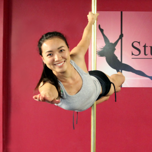 Level 7 student Joanne holding a Superman pose